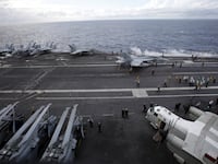 A picture of U.S. Navy F/A-18 Super Hornet fighters are seen on the deck of the USS Ronald Reagan, a super carrier. Two U.S. Navy sailors have been arrested on charges related to national security and tied to China, AP News reported.