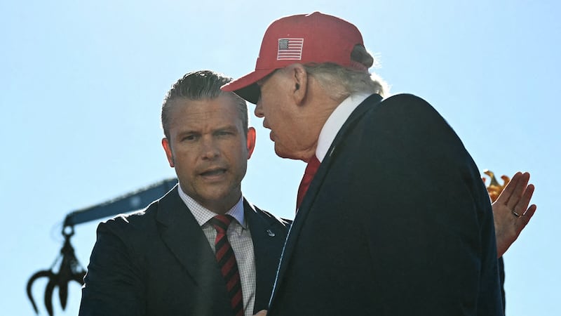 Trump shakes hands with Defense Secretary Pete Hegseth before speaking at Anduril Industries in Sparrows Point, Maryland, on October 6, 2026.