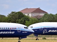 A Boeing 737-10 Max (L) prepares to take off in front of a Boeing 777-9 (R) at the 54th International Paris Air Show at Le Bourget Airport, north of Paris, France on June 21, 2023.