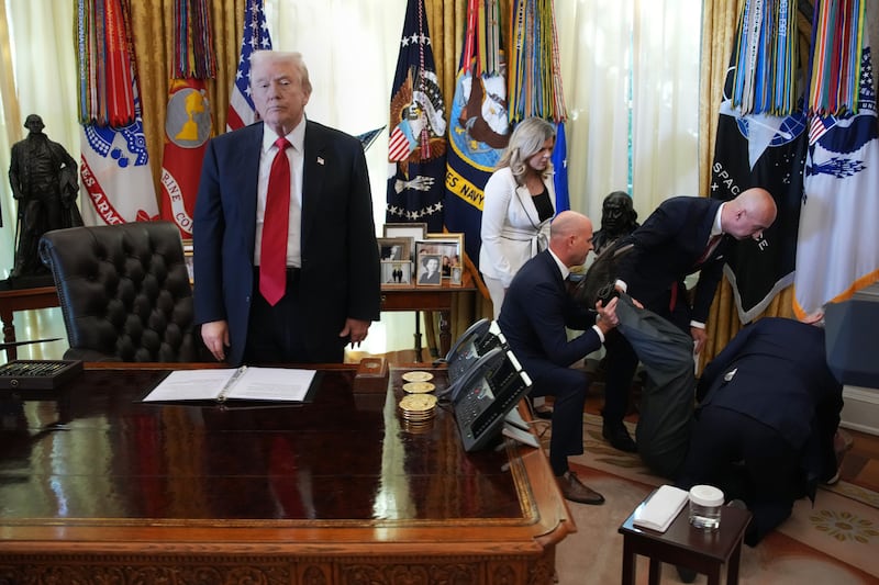 WASHINGTON, DC - NOVEMBER 06: U.S. President Donald Trump stands by as attendees help a guest after he collapsed during during an event on lowering drug prices in the Oval Office at the White House on November 06, 2025 in Washington, DC. Trump announced that his administration has reached agreements with drugmakers Eli Lilly and Novo Nordisk that would lower the price of some GLP-1 weight loss medications. (Photo by Andrew Harnik/Getty Images)
