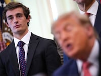 WASHINGTON, DC - OCTOBER 20: Conservative influencer Nick Shirley listens as U.S. President Donald Trump speaks during an event in the Oval Office of the White House on October 20, 2026 in Washington, DC. Trump and Vance announced a new $25 million dollar federal Fraud Whistle Blower Incentive Program with the Department of Justice to pay up to $30,000 to citizens who give verified tips that lead to a conviction or major enforcement action. Shirley received a $10,000 check after his viral video exposed a multi-million dollar daycare fraud scheme in Minnesota. (Photo by Andrew Harnik/Getty Images)