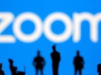 Small toy figures are seen in front of Zoom logo in this illustration picture taken March 15, 2021
