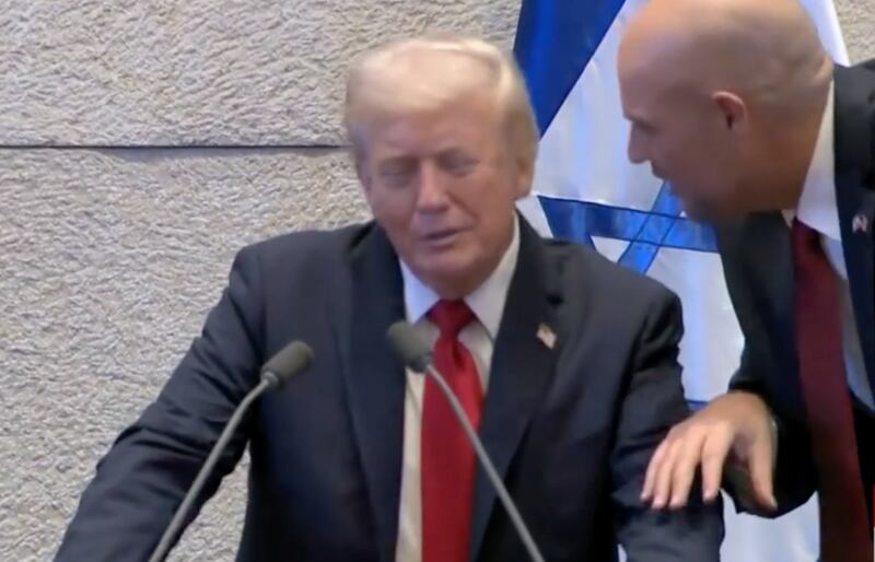 An aide tells Trump that it isn't his turn to speak.