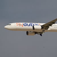 A Flydubai Boeing 737 MAX 8 performs a display flight at Al-Maktoum International Airport during the Dubai Airshow 2025 in Dubai on November 17, 2025.