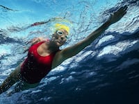 A photo including a film still of Annette Bening as Diana Nyad in the film NYAD on Netflix