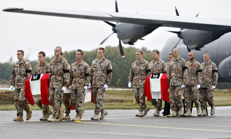The coffins of two Danish soldiers killed in the Helmand province in Afghanistan are carried out of a military tranport plane upon its arrival in Jutland, Denmark.