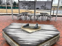 Shoes remain anchored to the pedestal where the rest of the Jackie Robinson memorial statue went missing after thieves stole it Wednesday night.