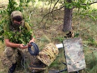 A Ukrainian soldier uses the Starlink system during military exercises in the Chernihiv region, Ukraine