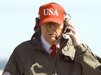 U.S. President Donald Trump observes naval flight demonstrations on the deck of the USS George H.W. Bush aircraft carrier.