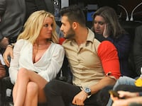 Britney Spears and Sam Asghari attend a basketball game between the Los Angeles Lakers and the Golden State Warriors at Staples Center on November 29, 2017.