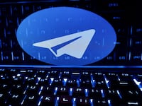 A keyboard is placed in front of a displayed Telegram logo in this illustration taken Feb. 21, 2023.