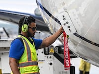 Workers of United Airlines prepare a plane to take off at George Bush Intercontinental Airport on July 25, 2025, in Houston, Texas. (Photo by RONALDO SCHEMIDT / AFP) (Photo by RONALDO SCHEMIDT/AFP via Getty Images)