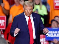 Donald Trump dances as he walks on stage during a campaign rally at Van Andel Arena in Grand Rapids, Michigan on November 5, 2024.