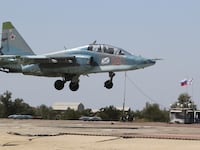 A Russian Sukhoi Su-25 jet fighter flies during a drill at the Nitka training complex