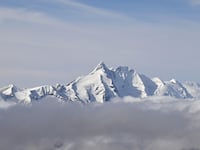 A photo taken on October 12, 2024 from the Sonnblick Observatory near Rauris, Austria, shows the Grossglockner, with 3798 metres Austria's highest mountain, in the Hohe Tauern mountain range. Experts say warmer temperatures across the Alps driven by climate change are accelerating glacier melt and thawing permafrost -- the year-round ice found at high altitude that binds together giant slabs of rock. This has increased the danger of sudden rockfalls and landslides, damaging paths and adding stress to the mountains' often-ageing huts. Austria's Alpine clubs are currently closing up to four huts a year as they have become unsafe or too costly to be maintained. (Photo by KERSTIN JOENSSON / AFP) (Photo by KERSTIN JOENSSON/AFP via Getty Images)