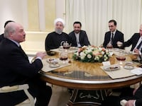 Russian President Vladimir Putin, Iranian President Hassan Rouhani, Turkish President Recep Tayyip Erdogan and President of Belarus Alexander Lukashenko sitting together at a table.