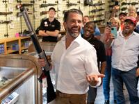 Donald Trump Jr., son of US President Donald Trump, holds a shotgun at Tombstone Tactical gun store in Phoenix, Arizona, on October 23, 2024.