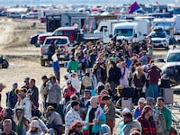 Hundreds of Burning Man attendees who planned to leave on buses wait for information about when they will be able to leave on Labor Day, after a rainstorm turned the site into mud September 4, 2023.