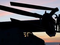 A U.S. Marine maintenance personal checks an MV-22B Osprey aboard the USS Bataan, a U.S. Navy Wasp-class amphibious assault ship.