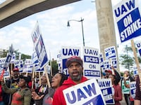 Protesters march through the streets of downtown Detroit amid UAW strike