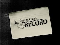 Photo illustration of a beige newspaper with the Marion County Record logo distorted on top with distressed texture on a black background