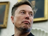 WASHINGTON, DC - MAY 21: Elon Musk listens as reporters ask U.S. President Donald Trump and South Africa President Cyril Ramaphosa questions during a press availability in the Oval Office at the White House on May 21, 2025 in Washington, DC. Relations between the two countries have been strained since Trump signed an executive order in February that claimed white South Africans are the victims of government land confiscation and race-based “genocide,” while admitting some of those Afrikaners as refugees to the United States. Trump also halted all foreign aid to South Africa and expelled the country’s Ambassador to the U.S., Ebrahim Rasool. (Photo by Chip Somodevilla/Getty Images)