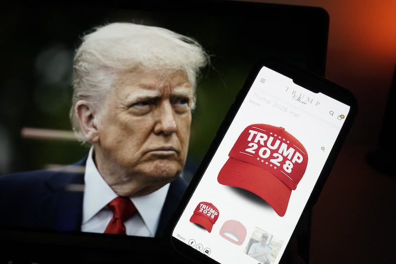An image of US President Donald Trump alongside a smartphone displaying a red 'Trump 2028' cap on the Trump Store website.