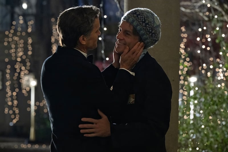 Matt Bomer and Jonathan Bailey hug in a still from ‘Fellow Travelers’