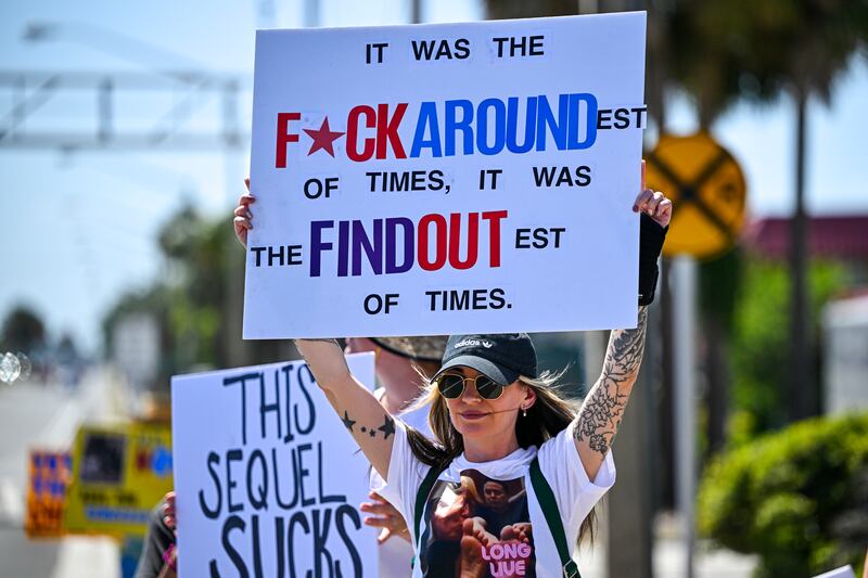 Demonstrators rally against President Donald Trump on April 19, 2025, in Cocoa, Florida.
