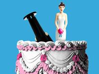 Bride and groom cake topper on a vintage wedding cake with the groom upside down