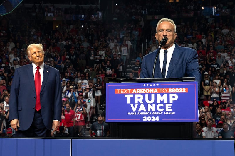 Robert F. Kennedy Jr. (R) speaks as Republican presidential nominee, former U.S. President Donald Trump listens during a campaign rally at Desert Diamond Arena on August 23, 2024 in Glendale, Arizona