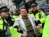 Metropolitan Police officers arrest British far-right activist Tommy Robinson during a demonstration in central London on November 26, 2023 to protest against antisemitism. (Photo by JUSTIN TALLIS / AFP) (Photo by JUSTIN TALLIS/AFP via Getty Images)
