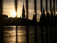 Kremlin tower through a fence on the empty Red Square in central Moscow