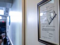 A copy of a the US Court of Appeals for the DC Circuit order against the Associated Press, is signed by President Donald Trump, framed and displayed on the wall at the entrance of the Brady Press Briefing Room at the White House on July 24, 2025 in Washington, DC. The order announes that the Trump administration could block The Associated Press from covering the president in certain spaces. (Photo by ANDREW CABALLERO-REYNOLDS / AFP) (Photo by ANDREW CABALLERO-REYNOLDS/AFP via Getty Images)