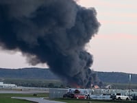 Fire and smoke mark where a UPS cargo plane crashed near Louisville Muhammad Ali International Airport on November 04, 2025 in Louisville, Kentucky.