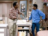 THE COSBY SHOW -- "One More Time" Episode 7 -- Air Date 11/01/1984 -- Pictured: (l-r) Bill Cosby as Doctor Heathcliff 'Cliff' Huxtable, Malcolm-Jamal Warner as Theodore 'Theo' Huxtable (Photo by R.M. Lewis Jr./NBCU Photo Bank/NBCUniversal via Getty Images via Getty Images)