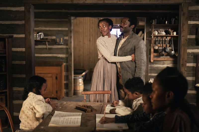 Lauren E. Banks and David Oyelewo hugging in a scene from Lawmen: Bass Reeves
