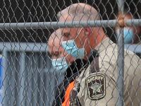 A law enforcement officer goes down while opening a gate for fired Minneapolis police officer Derek Chauvin