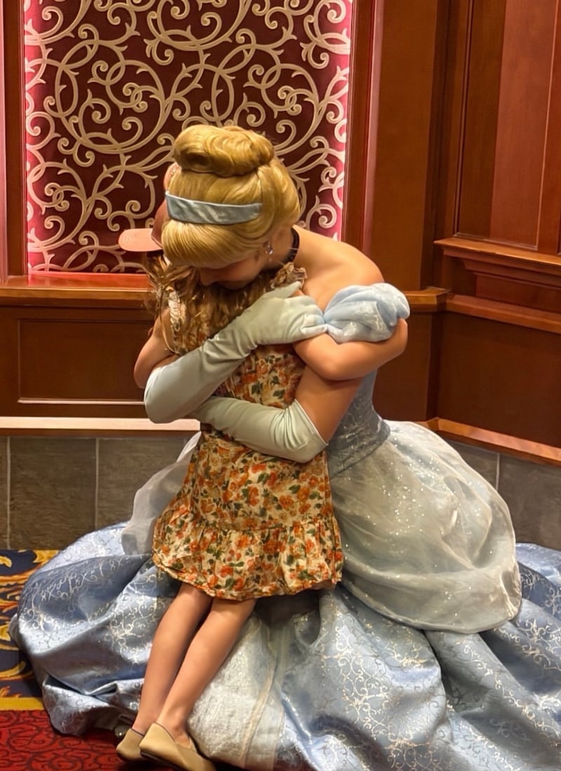 Princess Lillibet is pictured in a May 11 Instagram post while hugging Princess Cinderella in Sleeping Beauty Castle at Disneyland.
