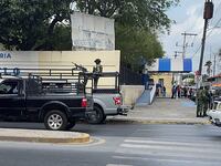 A man with a machine gun in the back of a truck
