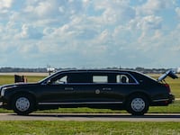 The US President's official vehicle known as "The Beast", drives with its trunk open, as US President Donald Trump's motorcade travels to Palm Beach International Airport in West Palm Beach, Florida, on November 9, 2025. Trump is returning to Washington DC after spending part of the weekend at his Florida residence of Mar-a-Lago. (Photo by Jim WATSON / AFP) (Photo by JIM WATSON/AFP via Getty Images)