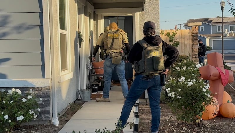 Two uniformed FBI officers on a doorstep