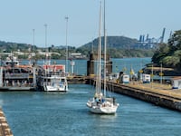 Ships passing through Miraflores Locks in the Panama Canal.