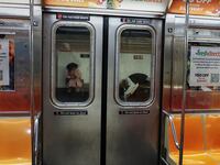 The view from the inside of a New York City subway car in Manhattan.