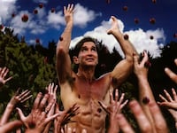 A photo including a still from the docuseries How to Become A Cult Leader on Netflix.