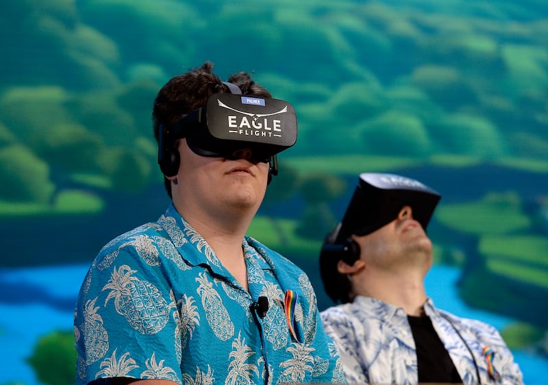 LOS ANGELES, CA - JUNE 13: Palmer Luckey, co-founder of Oculus VR Inc., left, plays the new video game "Eagle Flight VR" during an Ubisoft news conference before the start of the E3 Gaming Conference on June 13, 2016 in Los Angeles, California. (Photo by Kevork Djansezian/Getty Images)
