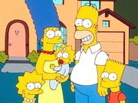 A still of a 90s episode of The Simpsons shows the entire Simpsons family posing outside of their house.