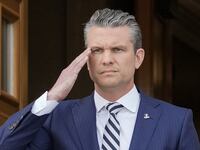 US Defense Secretary Pete Hegseth (R) salutes as national anthems are played at the Pentagon in Washington, DC on April 16, 2025.