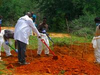 Workers exhume a mass grave in Kenya