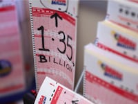 A photo of a batch of blank lottery tickets waiting to be filled out. On one of them, someone has written in black marker, “1.35 billion,” the jackpot.